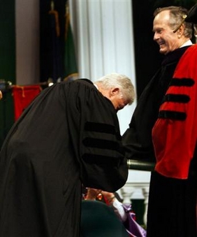 Former U.S. President Bill Clinton (D) bows to Former U.S. President George Bush (R)