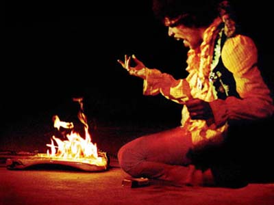 Satanic initiate Jimi Hendrix gets power from a fire.